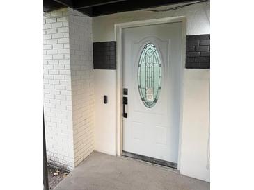 Stylish white front door with decorative glass window and painted brick surround at 104 W Wildwood St, Tampa, FL 33613