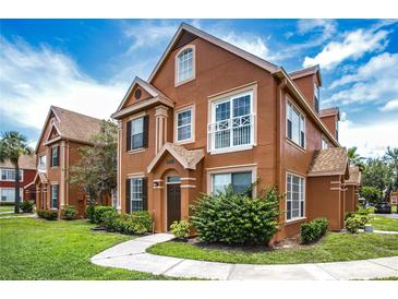Inviting two-story home with well-manicured lawn and charming architectural details on a beautiful sunny day at 10520 White Lake Ct # 10520, Tampa, FL 33626