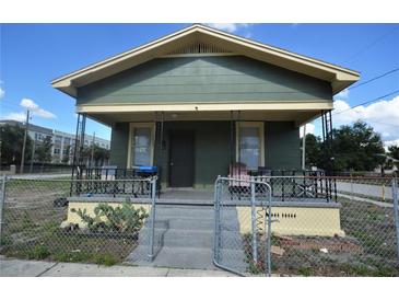 Charming single-story home with a fenced front yard, porch, and well-maintained exterior at 3009 N 13Th St, Tampa, FL 33605