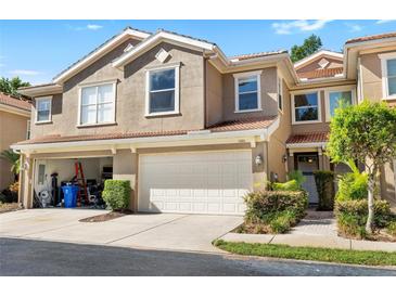 Charming two-story townhome with a two-car garage and well-maintained landscaping at 4920 Anniston Cir, Tampa, FL 33647