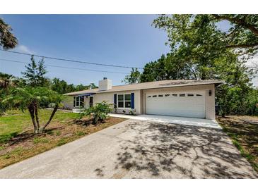 Charming single-story home with white brick, blue shutters, and a well-maintained front yard at 7332 Janczlik Dr, New Port Richey, FL 34652