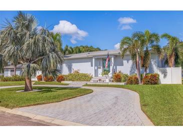Beautiful single story home with a circular driveway and gorgeous tropical landscaping at 827 Placido Ne Way, St Petersburg, FL 33704