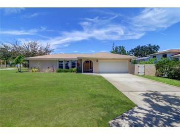 Charming single-story home with a well-maintained lawn, inviting curb appeal, and a two-car garage at 8289 136Th St, Seminole, FL 33776