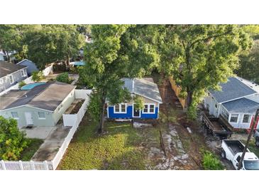 Charming blue single-story home with mature trees and a well-maintained front yard at 1513 W Mohawk Ave, Tampa, FL 33603