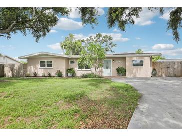 Charming single-story home with a well-maintained lawn, inviting curb appeal, and a light blue front door at 6220 Murdock Ave, Sarasota, FL 34231