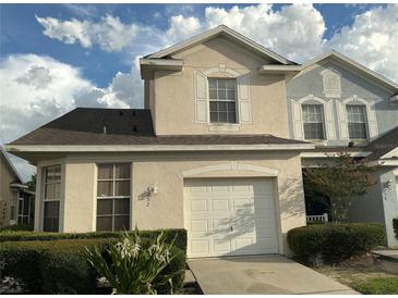 Charming two-story home featuring an attached garage and well-maintained front yard with mature landscaping at 6252 Olivedale Dr, Riverview, FL 33578