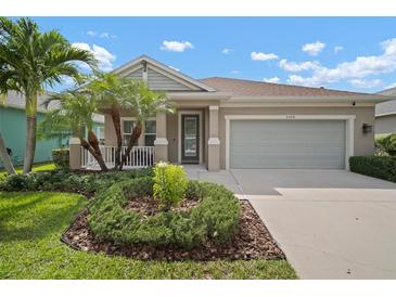 Charming single-story home with a well-manicured lawn and a cozy front porch and a two car garage at 6408 Seasound Dr, Apollo Beach, FL 33572