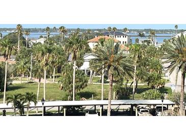 Beautiful community view with palm trees, water views and lovely architecture at 880 Mandalay Ave # C412, Clearwater Beach, FL 33767