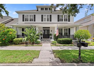 Charming two-story home with a welcoming front porch and well-manicured landscaping at 10003 Brompton Dr, Tampa, FL 33626