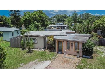 Charming single-story home featuring a quaint brick walkway and mature landscaping at 10549 112Th Ave, Largo, FL 33773