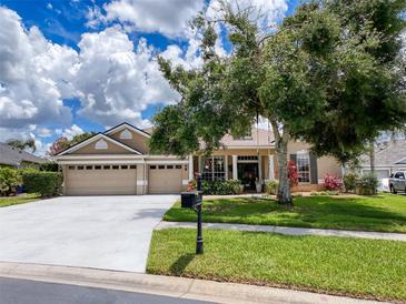 Charming single-story home boasts a well-manicured lawn, mature trees, and a spacious three-car garage at 22925 Collridge Dr, Land O Lakes, FL 34639