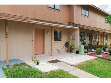 Charming townhome featuring a cozy porch and well-maintained landscaping at 4008 Pine Limb Ct, Tampa, FL 33614