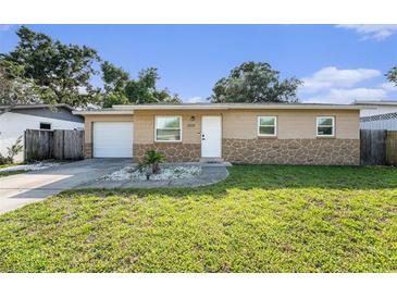 Charming single-story home featuring a manicured lawn and a welcoming front entrance at 5632 62Nd N St, St Petersburg, FL 33709