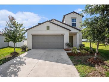 Charming two-story home featuring a spacious garage and well-maintained landscaping at 6347 Ten Acre Ct, Zephyrhills, FL 33541