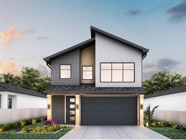 Modern two-story home with gray and white accents, large windows, and a two-car garage at 12236 Land St, Largo, FL 33773