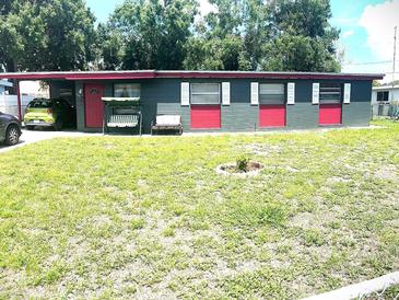 Charming single-story home featuring a well-maintained lawn and a cozy front porch swing at 2010 Warrington Way, Tampa, FL 33619