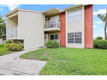 Charming two-story condo featuring a private balcony and well-maintained lawn, perfect for relaxed outdoor living at 302 Lake Parsons Grn # 104, Brandon, FL 33511