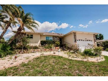 Charming single-story home with a well-kept front yard and tropical landscaping at 4434 Dewey Dr, New Port Richey, FL 34652