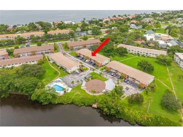 Scenic aerial view of waterfront condos, showcasing the community pool and convenient parking at 4510 Overlook Ne Dr # 224, St Petersburg, FL 33703