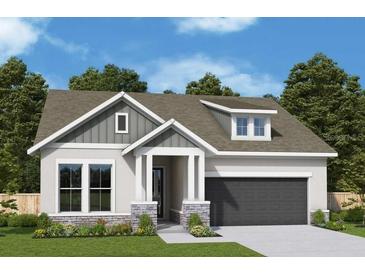 Charming single-Gathering home with a gray roof, stylish stone accents, and a dark-colored garage at 5033 Chapel Row Ave, Apollo Beach, FL 33572