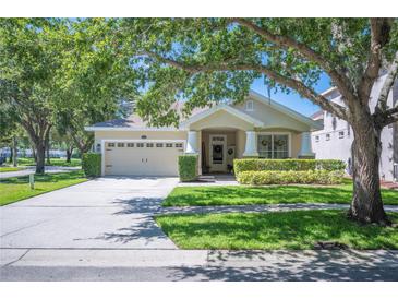 Charming single Gathering home with a well-maintained lawn and two car garage at 5102 Pheasant Woods Dr, Lutz, FL 33558