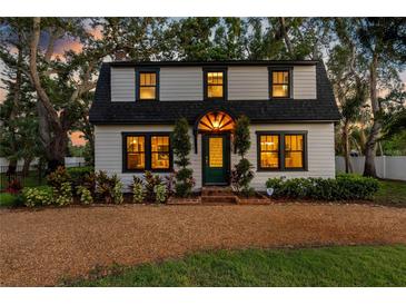 Charming two-story home with a gambrel roof, a welcoming front yard, and stylish curb appeal at 5518 21St S Ave, Gulfport, FL 33707