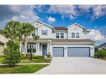 Beautiful two-story home with a two-car garage, manicured lawn, and lush landscaping at 2812 Long Bow Way, Odessa, FL 33556