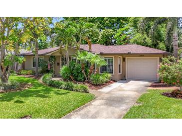 Charming one-story home with a well-maintained lawn and lush landscaping at 3354 52Nd N St, St Petersburg, FL 33703