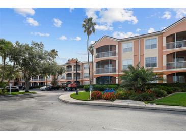 Beautiful condo building with manicured landscaping, sidewalks, and a tropical feel at 5000 Culbreath Key Way # 1-112, Tampa, FL 33611