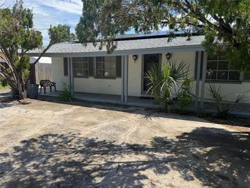 Charming single-story home featuring an inviting front porch and mature landscaping at 11423 77Th Ave, Seminole, FL 33772