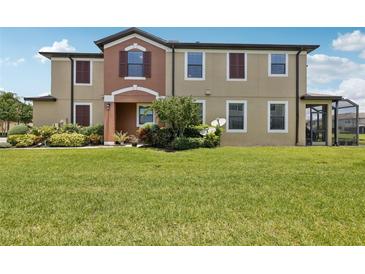 Charming townhome with lush landscaping and a well-manicured lawn creates an inviting curb appeal at 11617 Crowned Sparrow Ln, Tampa, FL 33626