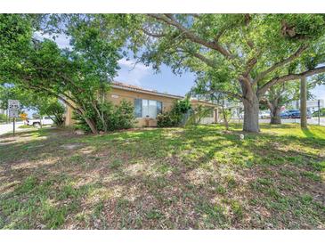 Charming single-story home with a well-maintained lawn and mature trees offering ample shade at 1269 Drew St, Clearwater, FL 33755