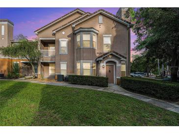 Inviting home exterior with well-manicured lawn and lush landscaping; featuring a charming entrance and bay window at 10436 Villa View Cir, Tampa, FL 33647