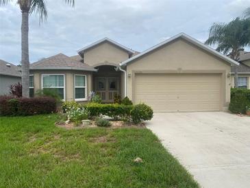 Charming single-story home with well-manicured lawn, fresh landscaping and an attached two car garage at 29702 Tee Shot Dr, San Antonio, FL 33576