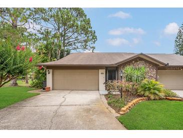 Lovely home with a two-car garage, stone accents, and neatly manicured front yard at 3902 Shoreside Cir, Tampa, FL 33624