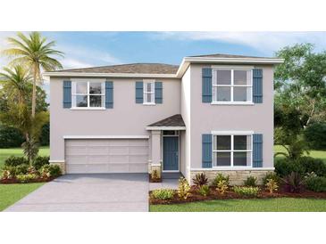 Charming two-story home featuring blue shutters, a two-car garage, and well-maintained landscaping at 7136 Beaverhead Ln, Land O Lakes, FL 34638