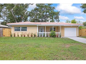 Charming single story home featuring a light color scheme, a well maintained lawn, and an attached garage at 2333 Indigo Dr, Clearwater, FL 33763