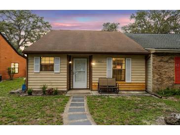 Charming single-story home with neutral siding, white shutters, and a cozy front bench at 35077 Whispering Oaks Blvd, Dade City, FL 33523
