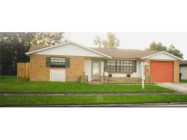 Charming single-story home with brick accents, a well-maintained lawn, and an inviting facade at 4219 Gray Squirrel Ln, New Port Richey, FL 34653