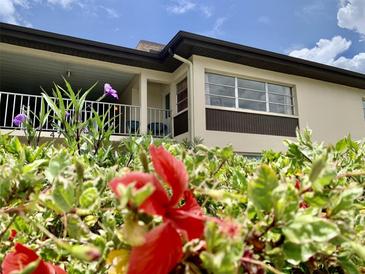 Inviting condo featuring private balcony and lush landscaping at 4712 Marine Pkwy # 203, New Port Richey, FL 34652