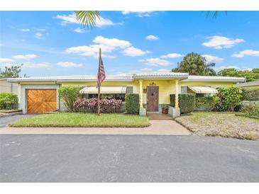 Charming single-story home featuring a well-manicured front yard and inviting entrance at 5821 52Nd N Ave, Kenneth City, FL 33709