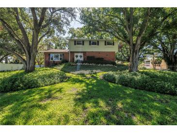 Charming two-story home featuring a brick facade and lush landscaping surrounding the property at 6505 Cedar Ne St, St Petersburg, FL 33702