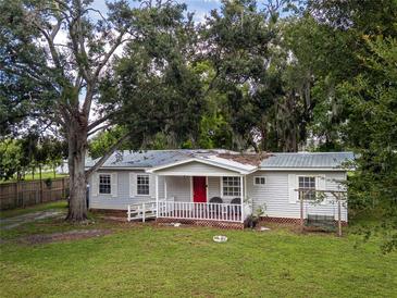 Charming single-story home with inviting front porch and lush green lawn, perfect for relaxation and outdoor enjoyment at 11704 Orange Grove Ter, Riverview, FL 33569