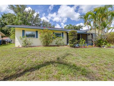 Charming single-story home featuring a well-maintained lawn, landscaping, and a screened entry at 153 Alpine Ct, Bradenton, FL 34208