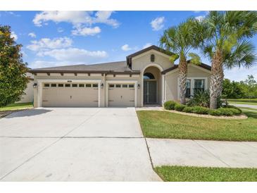 Charming single-Gathering home with a three-car garage and lush, tropical landscaping at 21837 Briske Morning Ave, Land O Lakes, FL 34637