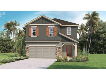 Charming two-story home featuring a neutral color scheme, stone accents, a two-car garage, and a neatly landscaped front yard at 5212 Salt Marsh Rd, Wimauma, FL 33598