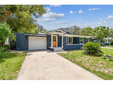 Charming single-story home with a well-manicured lawn and attached garage at 6401 N Central Ave, Tampa, FL 33604