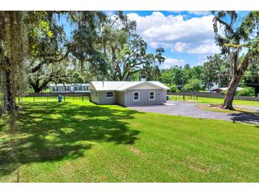 Charming home with a spacious front yard and mature trees offering shade at 9448 Mcintyre Rd, Brooksville, FL 34601