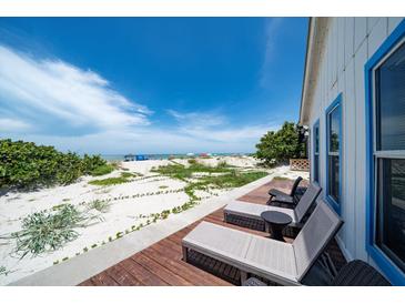 Inviting beachfront deck with lounge chairs offers serene ocean views and direct beach access at 960 Gulf Blvd # 5, Indian Rocks Beach, FL 33785