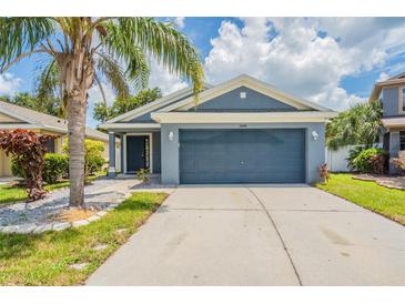 Charming one-story home with a well-manicured lawn and a two-car garage at 11448 Bay Gardens Loop, Riverview, FL 33569